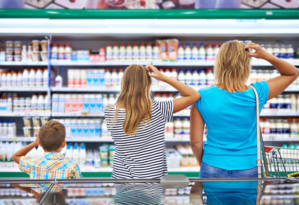 Family chooses dairy products in shop